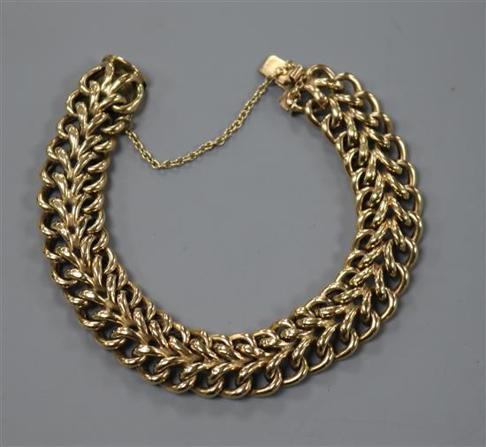 A yellow metal twin row curb link bracelet.